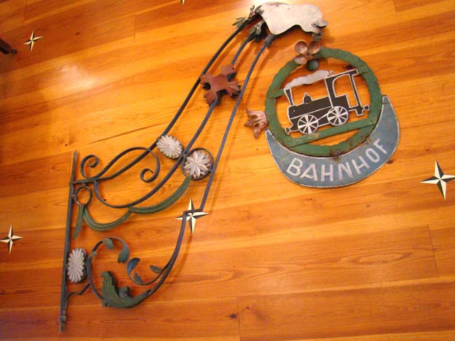 A late 19th century European wrought iron hanging sign from a railroad station